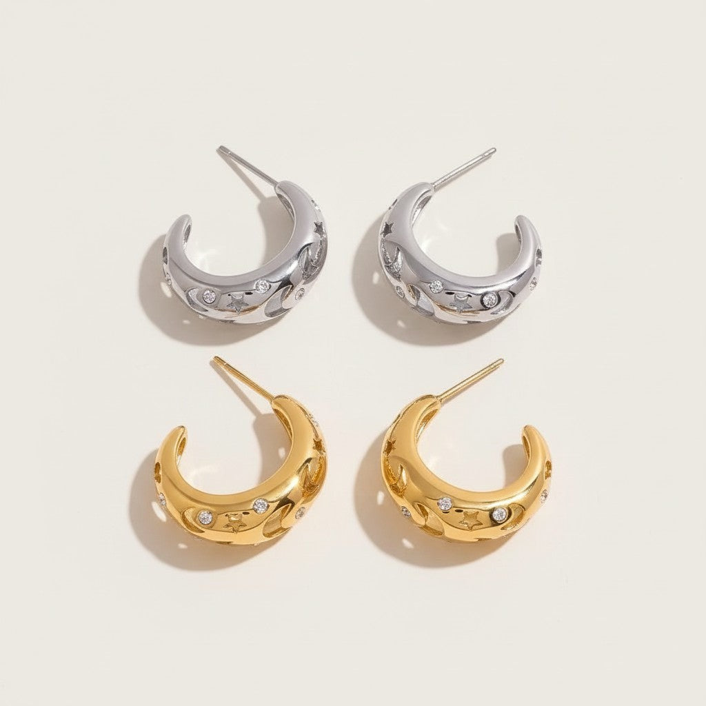 Seraphina Treasures gold and silver hollow hoop earrings with star and moon cutouts and cubic zirconia stones.