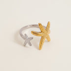 Seraphina Treasures Elysia open ring with two starfish, one gold and one silver, adjustable fit.