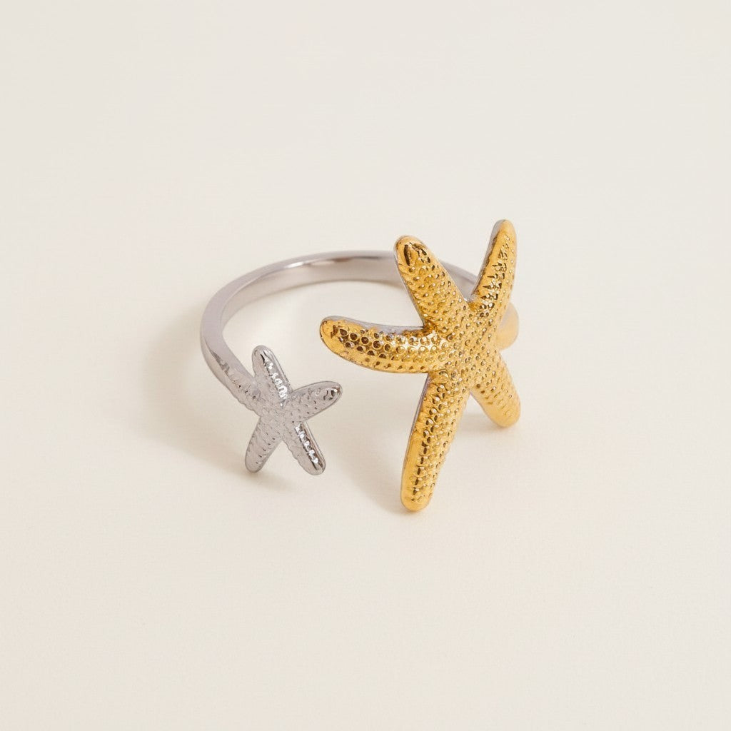 Seraphina Treasures Elysia open ring with two starfish, one gold and one silver, adjustable fit.