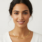 Seraphina Treasures Sterline gold herringbone necklace on a woman's neck, perfect for layering.
