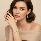 Seraphina Treasures Clytia bracelet and earring set with white pearls, gold accents, and square pendants featuring red strawberries.