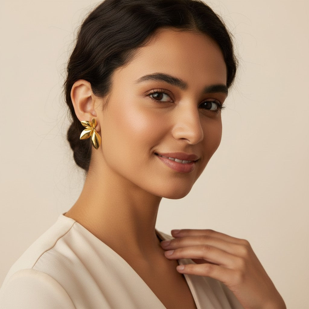 Seraphina Treasures Sylvara gold leaf earrings on a model. Lightweight and elegant.