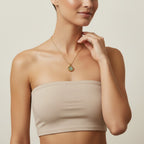 Seraphina Treasures Tegan necklace with a gold chain and a shell-shaped pendant featuring iridescent green and blue hues.