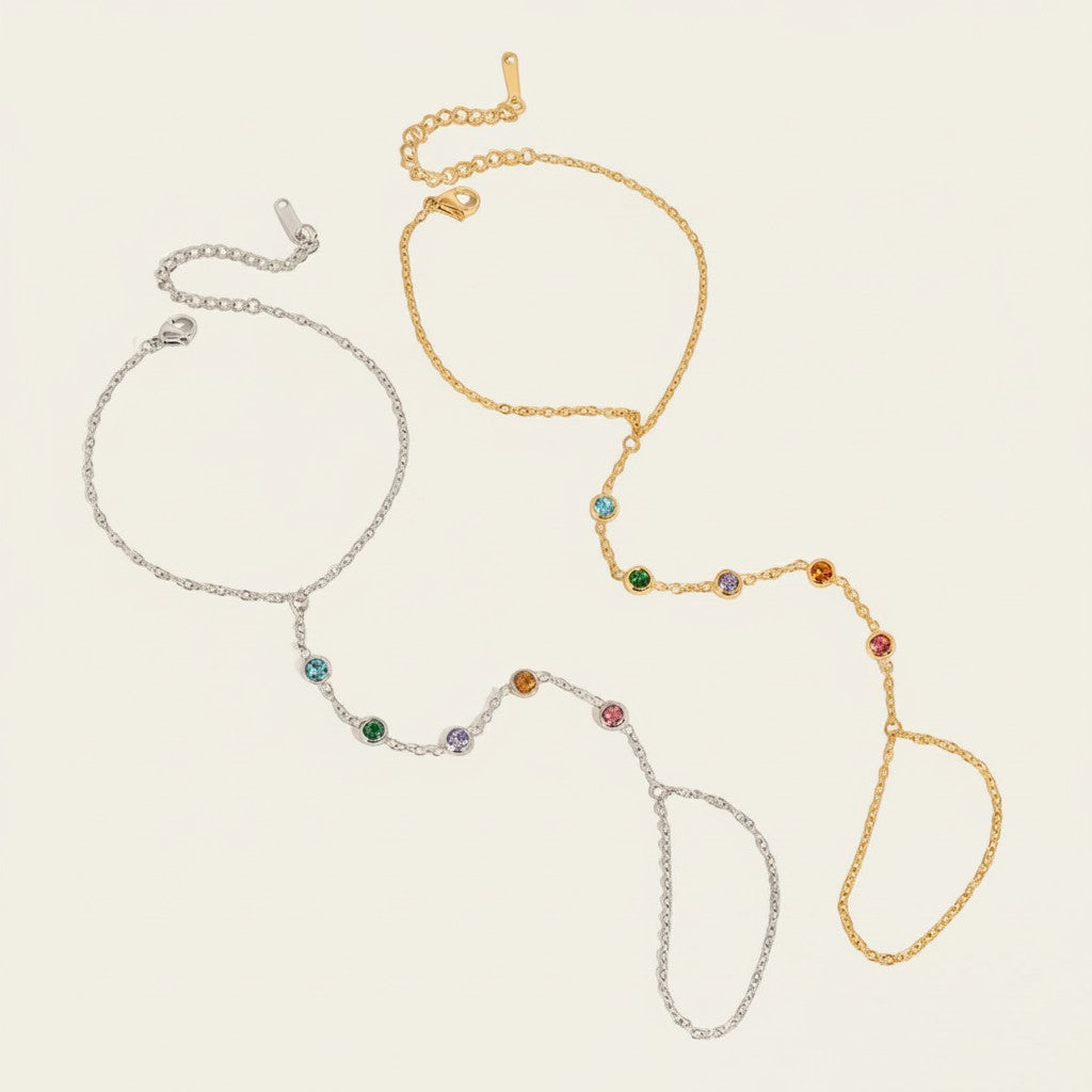Seraphina Treasures Thaleryn bracelet with connected finger loop, adorned with colorful zircon stones in gold and silver tones.
