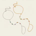 Seraphina Treasures Thaleryn bracelet with connected finger loop, adorned with colorful zircon stones in gold and silver tones.