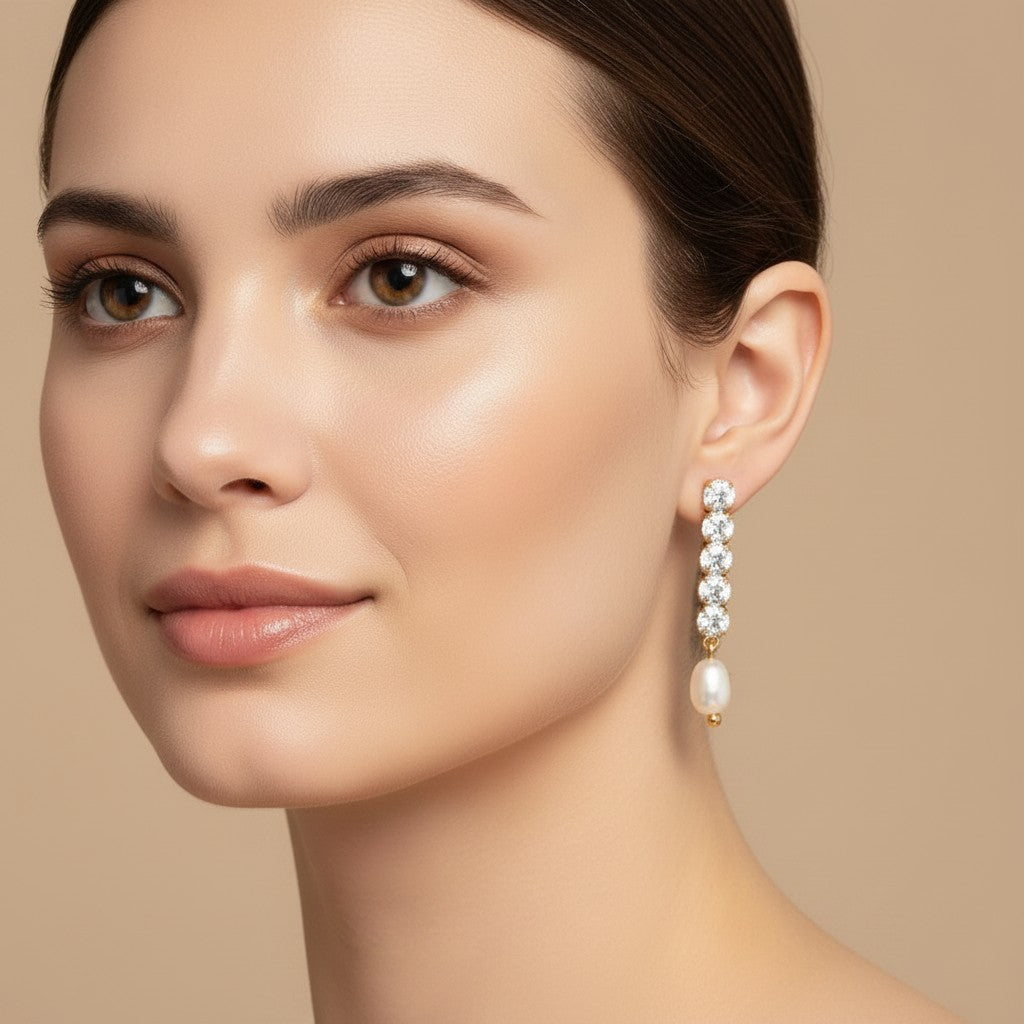 Seraphina Treasures Thalire earrings with freshwater pearls and clear crystals on a model.