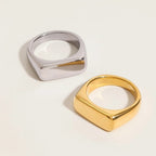 Seraphina Treasures Thalora ring in gold and silver finishes. Sleek, minimalist, geometric design with a smooth, polished surface.