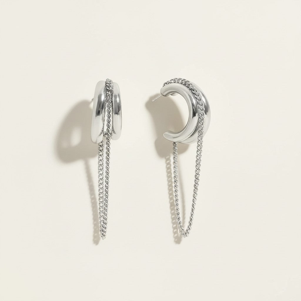 Seraphina Treasures Thryxis silver metal earrings with layered chains and curved design. Modern, elegant drop earrings.