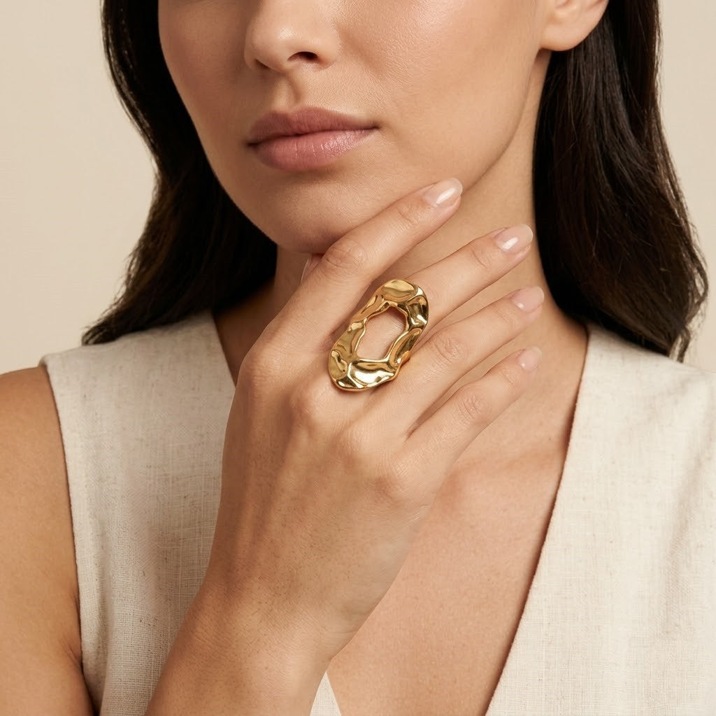 Seraphina Treasures Thyra gold ring with hammered texture and open design on a woman's hand.
