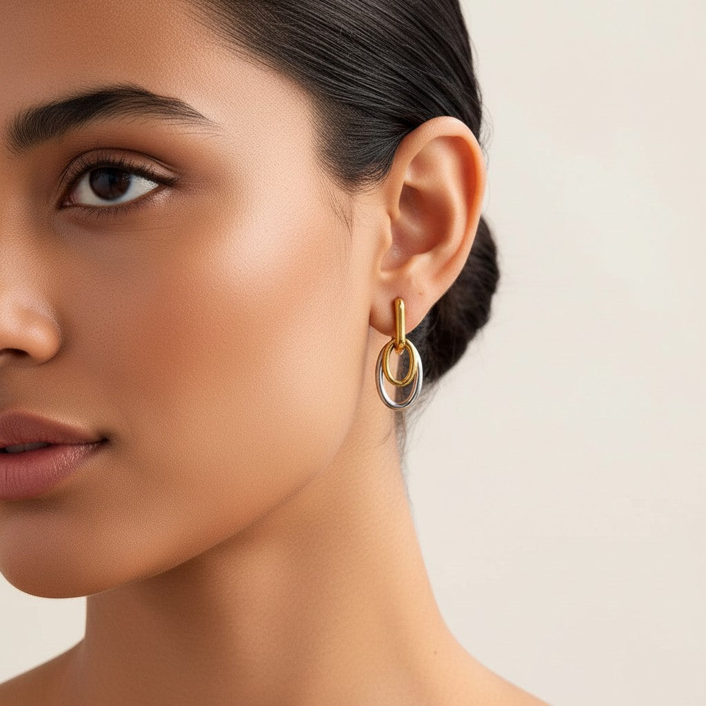 Seraphina Treasures Tiaris two-tone gold and silver interlocking oval drop earrings with minimalist geometric design.