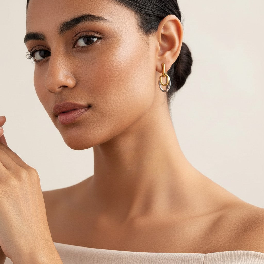 Seraphina Treasures Tiaris geometric drop earrings with interlocking gold and silver oval shapes.
