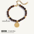 Seraphina Treasures Acantha bracelet with natural tiger eye stones and gold-tone accents, featuring a decorative coin charm.