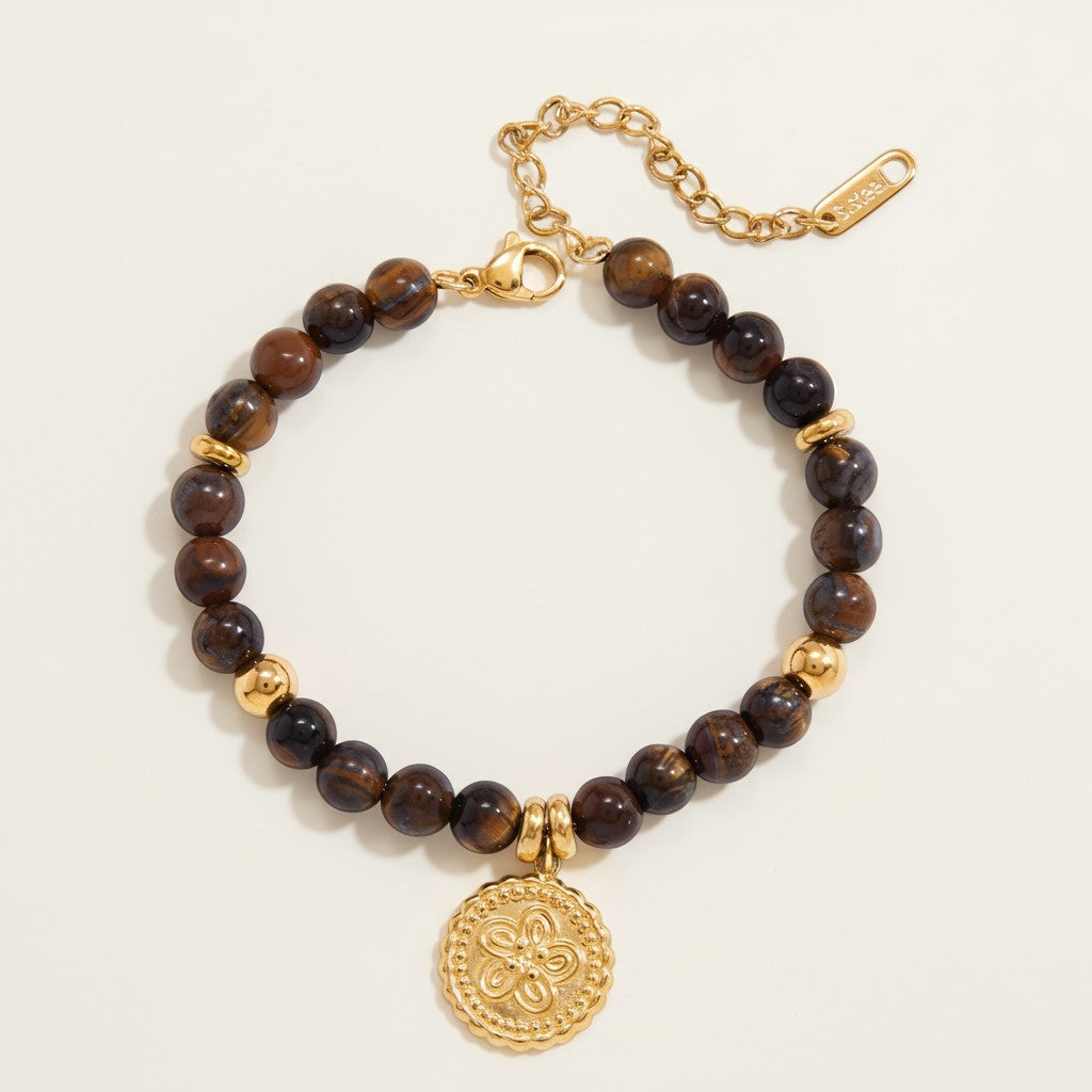 Seraphina Treasures Acantha bracelet with natural tiger eye beads and gold-tone accents, featuring a floral coin charm.