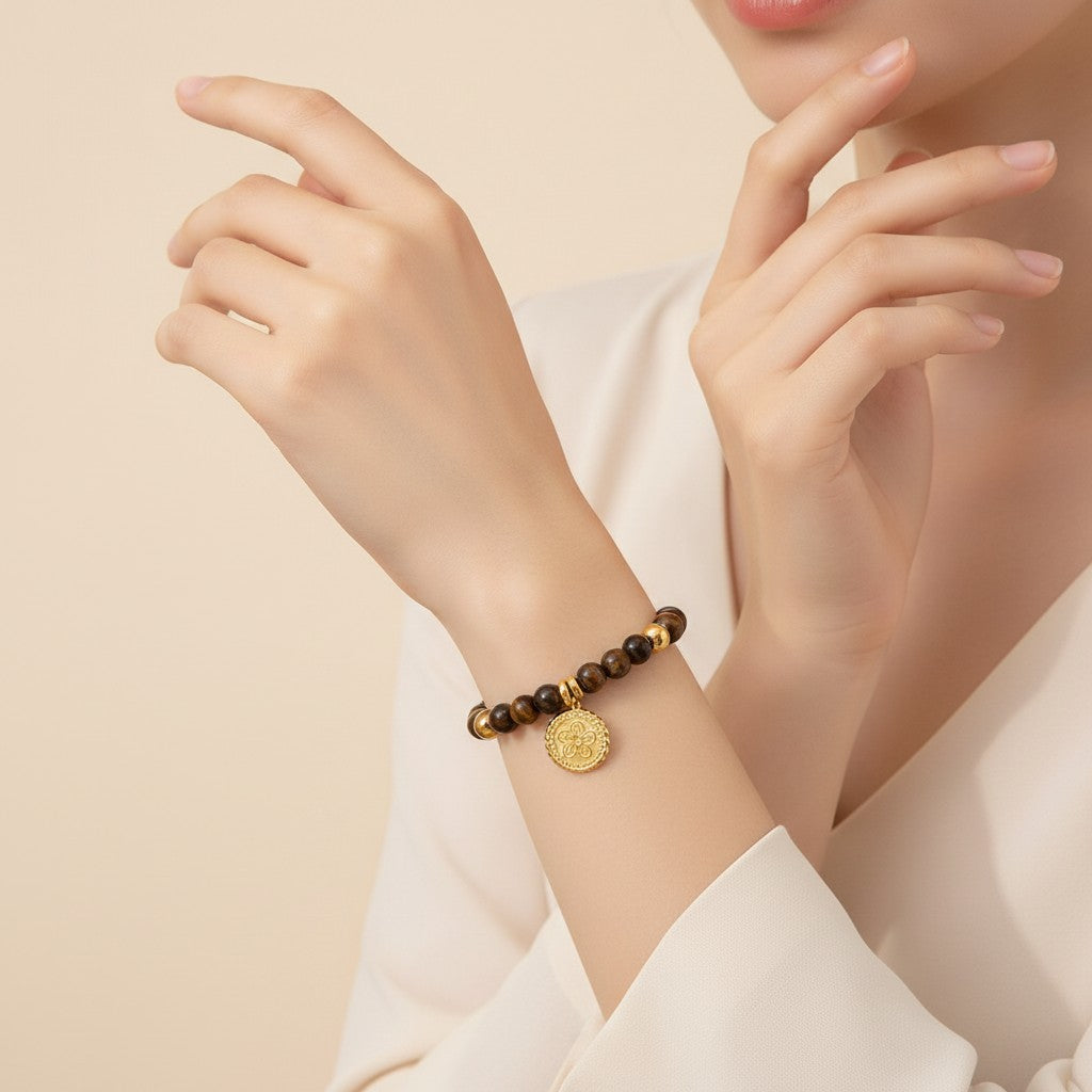 Seraphina Treasures Acantha bracelet with natural tiger eye beads and gold-tone flower charm. Adjustable length, waterproof, hypoallergenic.