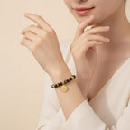 Seraphina Treasures Acantha bracelet with natural tiger eye beads and a gold-tone floral charm.