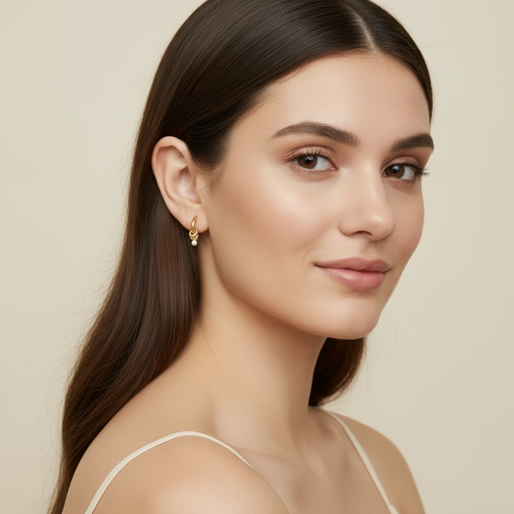 Seraphina Treasures Topazia gold hoop earrings with a dangling white zirconia stone.