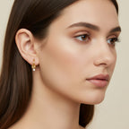 Seraphina Treasures Topazia gold hoop earrings with a knot detail and a dangling white zirconia stone.