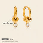 Seraphina Treasures Topazia gold hoop earrings with dangling white zirconia stones. Waterproof and hypoallergenic.