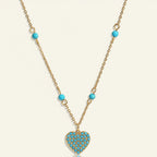 Seraphina Treasures Chione necklace with gold chain and turquoise heart pendant, accented with turquoise beads.