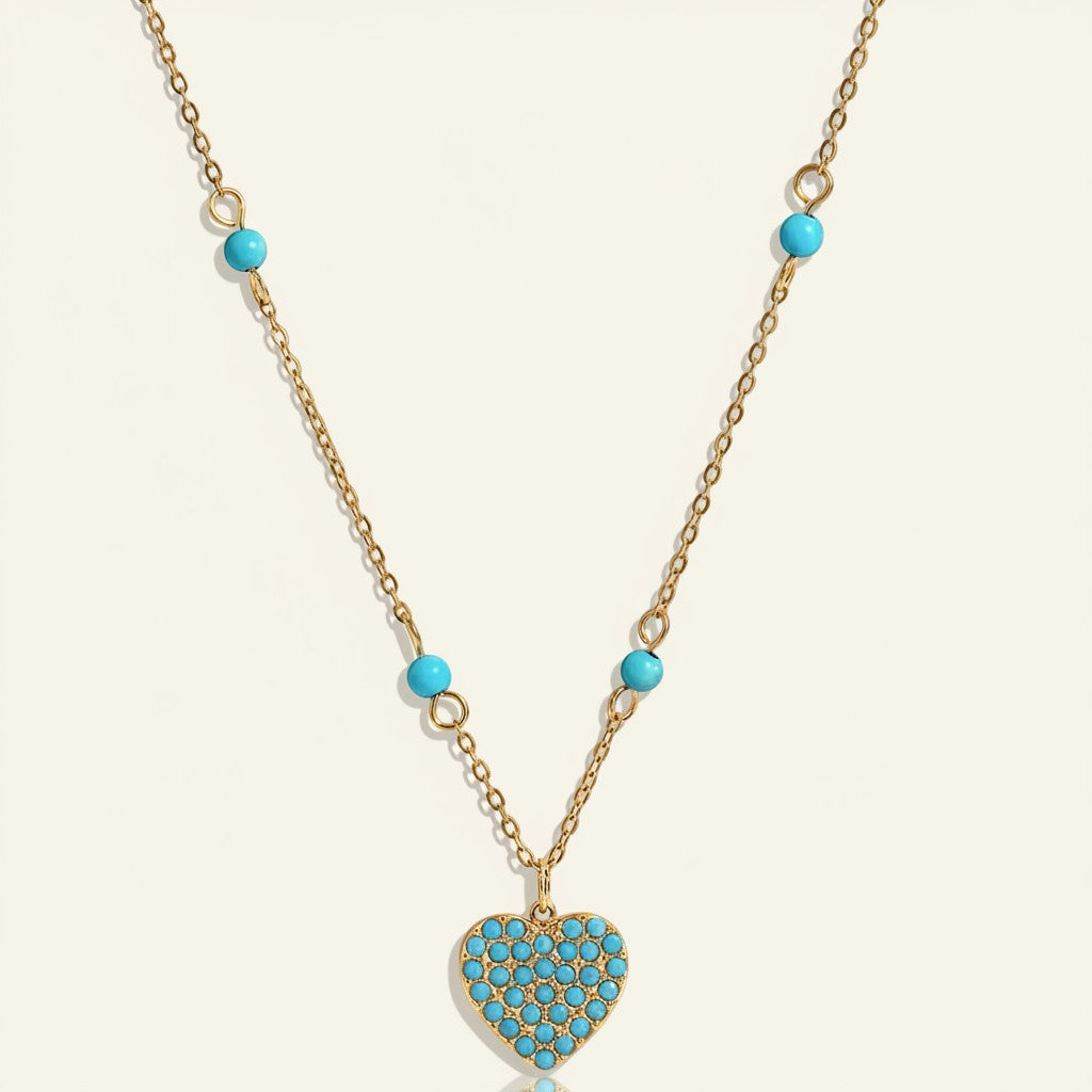 Seraphina Treasures Chione necklace with gold chain and turquoise heart pendant, accented with turquoise beads.
