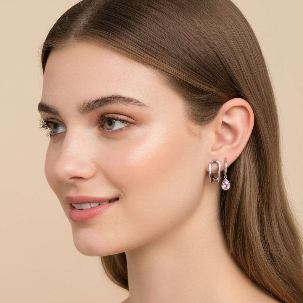 Seraphina Treasures Valencia earrings: silver safety pin style and hoop with pink teardrop gem.