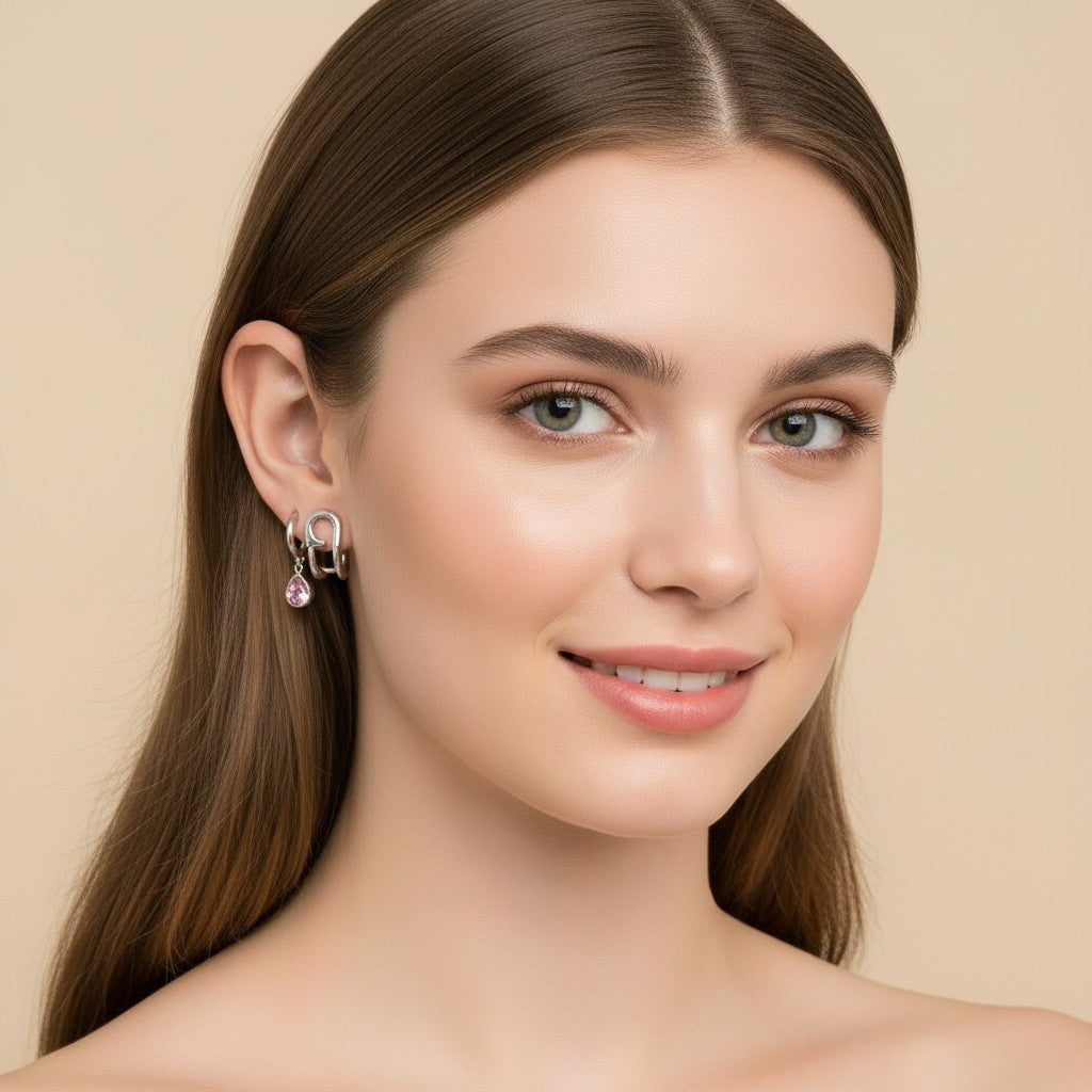 Seraphina Treasures Valencia silver earrings with pink teardrop gems. Modern curved design.