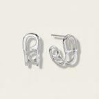 Seraphina Treasures Valencia silver-tone metal safety pin hoop earrings with a modern curved design.