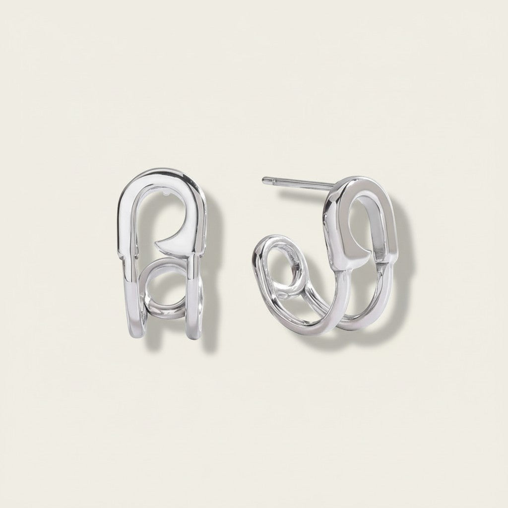 Seraphina Treasures Valencia silver-tone metal safety pin hoop earrings with a modern curved design.