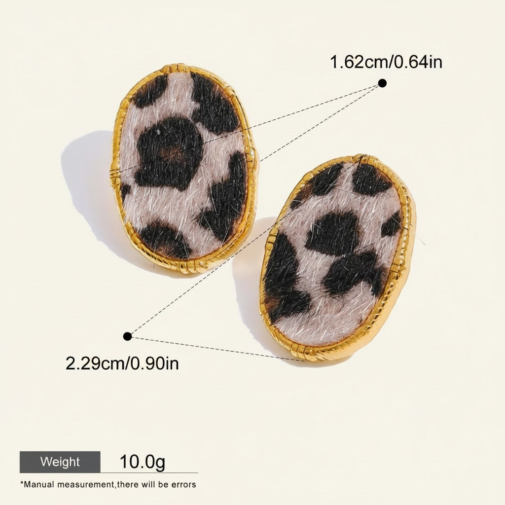 Seraphina Treasures Veloria Earrings with cow print fuzzy texture and gold trim. Oval shape, waterproof and hypoallergenic.