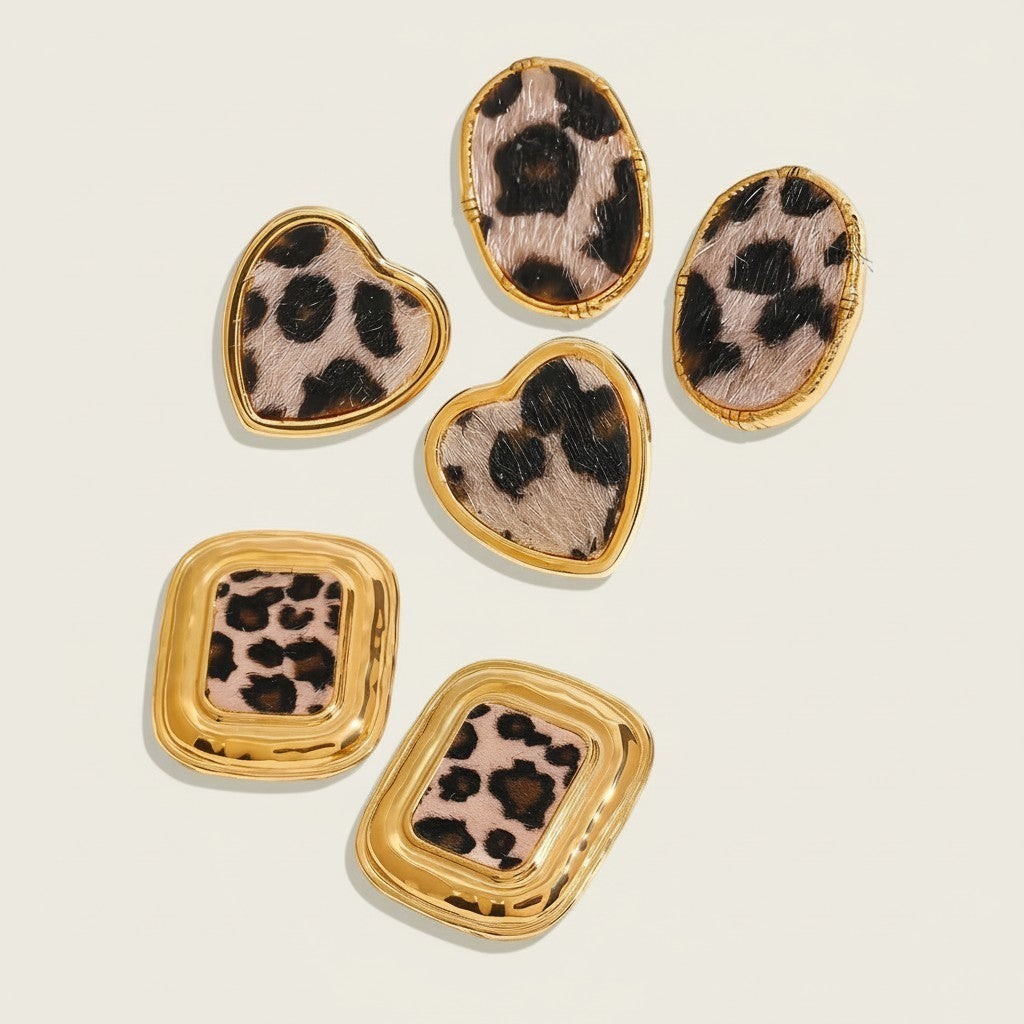 Seraphina Treasures Veloria Earrings: gold-tone frames with leopard print accents in heart and oval shapes.