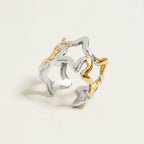 Seraphina Treasures Vespera open ring with intertwined silver and gold star motifs. Modern celestial design.
