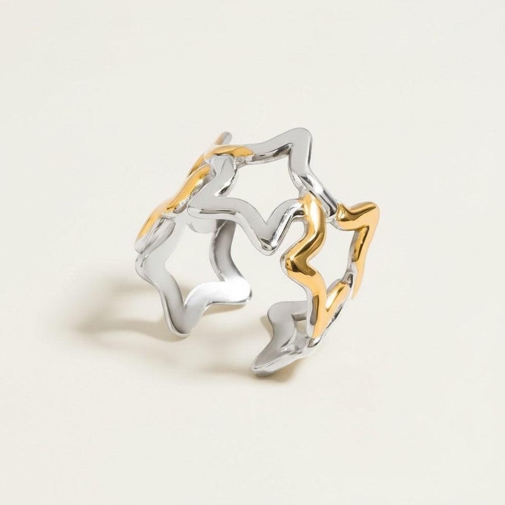 Seraphina Treasures Vespera open ring with intertwined silver and gold star motifs. Modern celestial design.