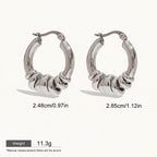 Seraphina Treasures Veyora silver tone hoop earrings with intertwined loops, 2.48cm and 2.85cm.