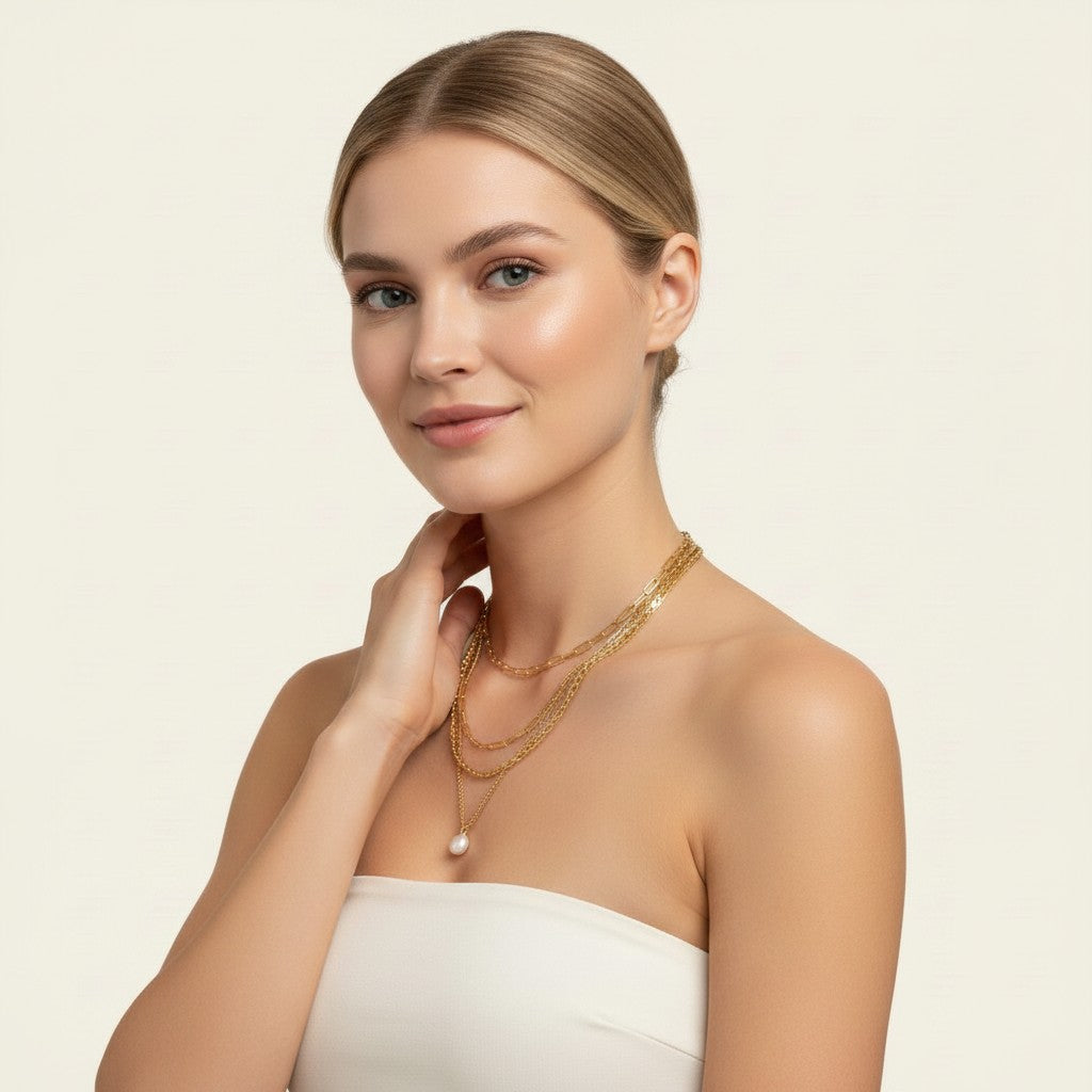 Seraphina Treasures Yasira layered gold necklace with pearl pendant on a woman.
