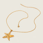 Seraphina Treasures Zahra gold starfish pendant necklace with a textured finish and delicate chain. Ocean-inspired design.