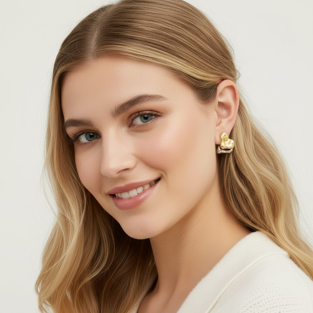 Seraphina Treasures Zaria earrings, gold and silver heart-shaped studs with a textured finish.