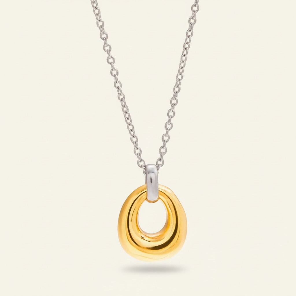 Seraphina Treasures Zephyrella necklace with a hollow gold-tone geometric pendant on a silver-tone chain.