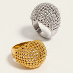 Seraphina Treasures Zerath rings in gold and silver, featuring a hollow, textured dome design with small beaded details. Stackable and versatile.