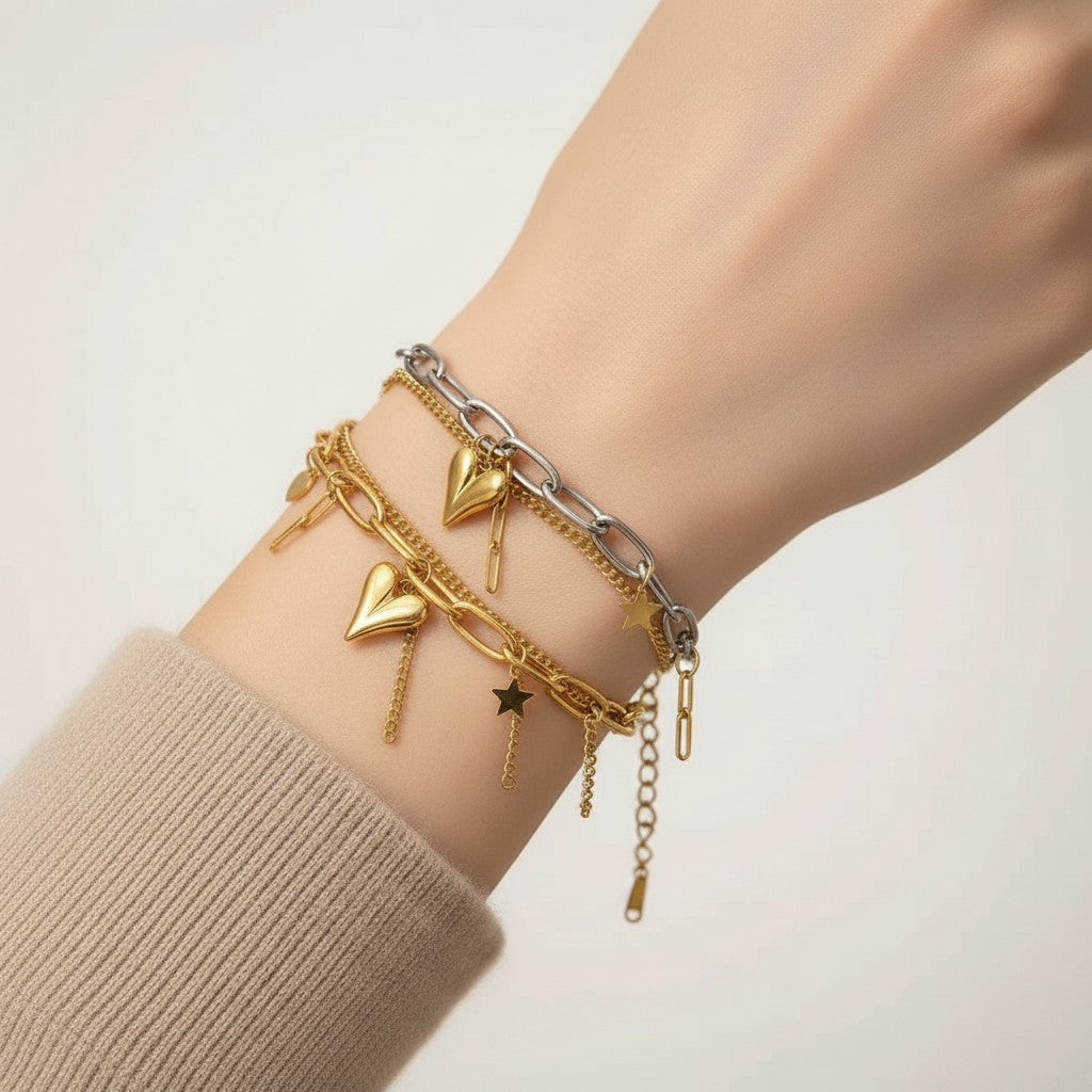 Seraphina Treasures Zorya two-layer bracelet with gold heart and star charms on a wrist.