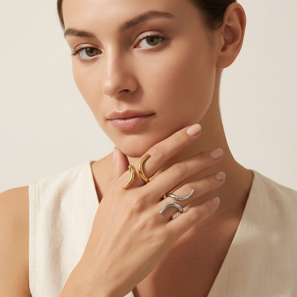 Seraphina Treasures Zyra ring in gold and silver, featuring a modern geometric open design on a woman's hand.