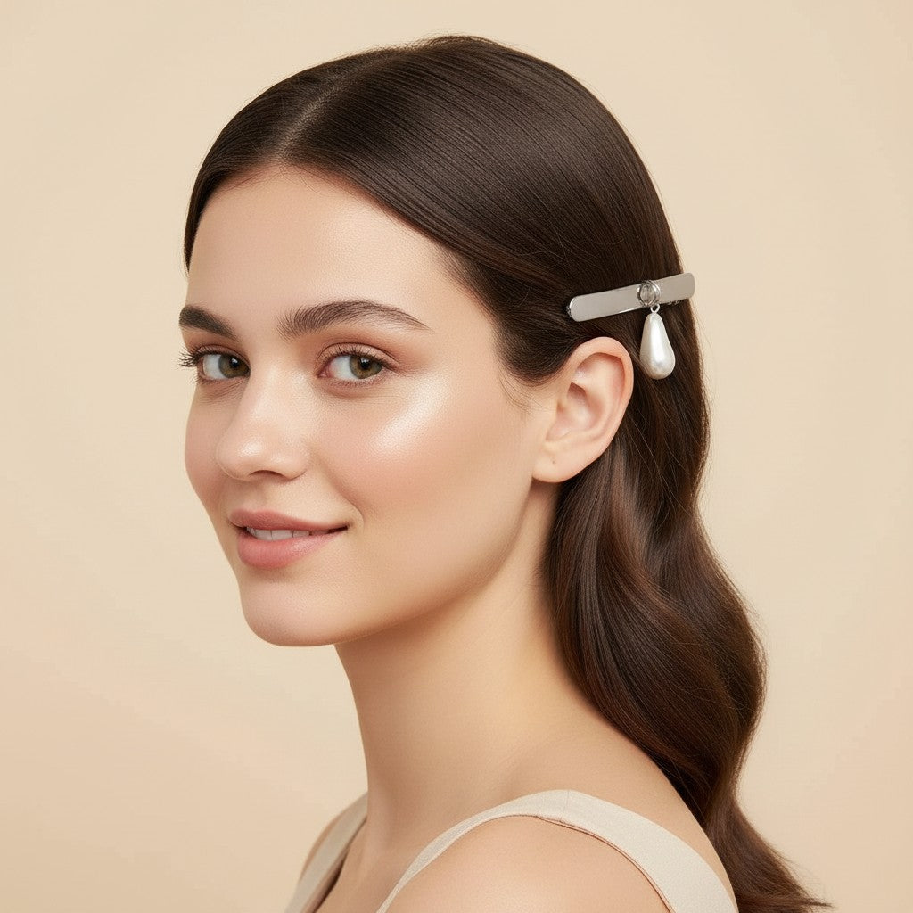 Seraphina Treasures Zyraea gold barrette with a large pearl drop and small amber accent.